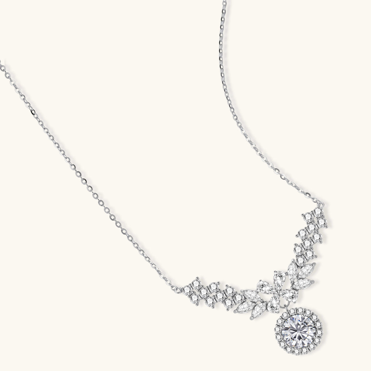Elegant sterling silver necklace featuring intricate wing-like design with brilliant moissanite stones on neutral background.