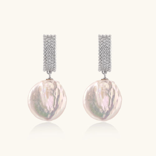 Rhodium-plated silver curved stud with pave stones and baroque pearl drop on white background
